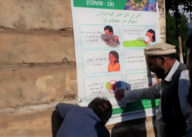 GCDP Staff pasting banners in Kumrat Valley